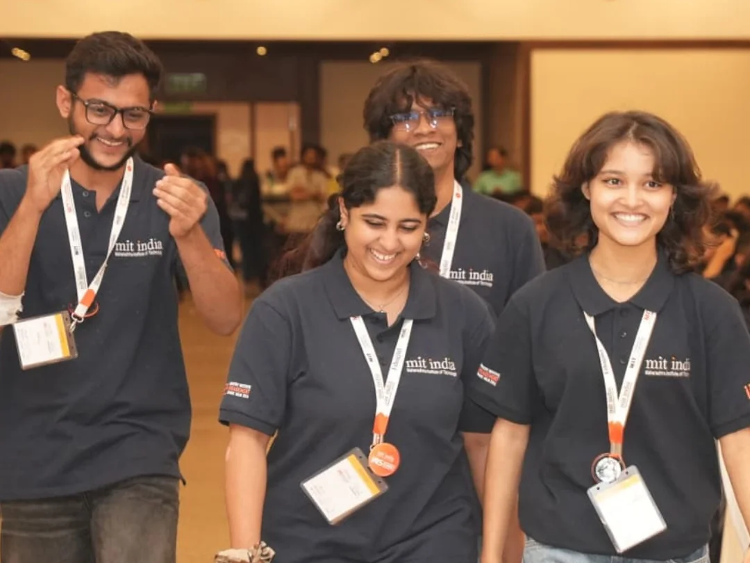 Four members of the Śaci team smiling as they walk together at an event