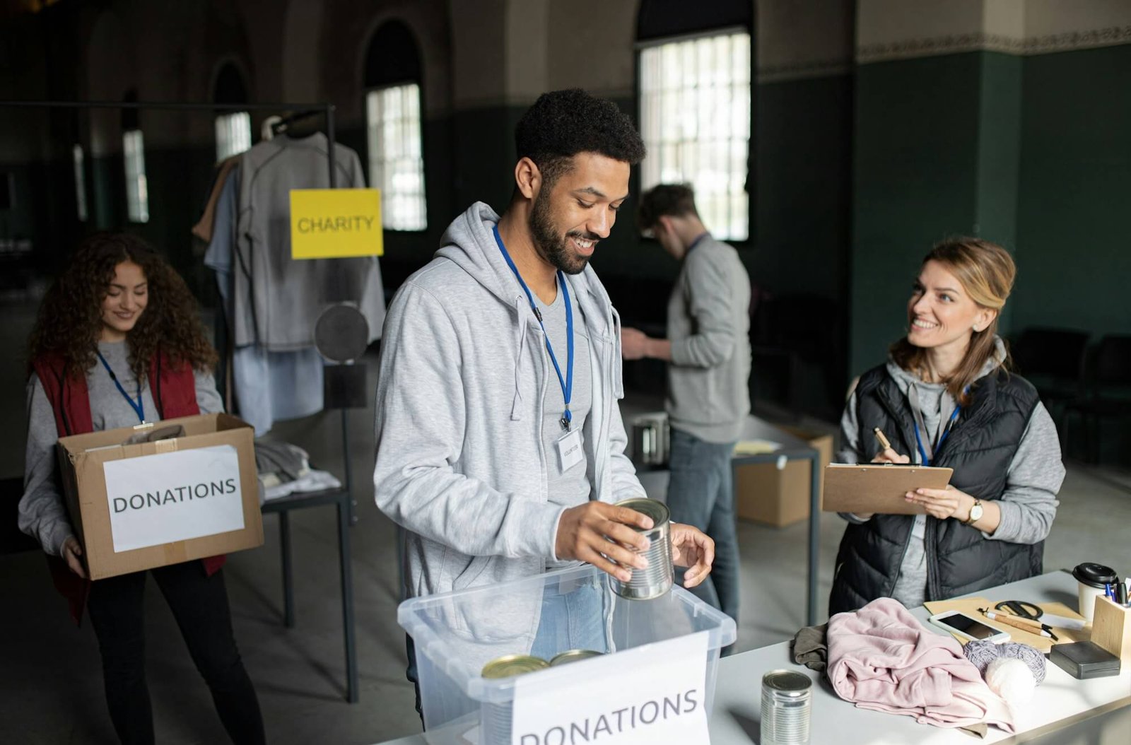 volunteers-working-in-community-charity-donation-center-sorting-out-clothes-and-canned-food-.jpg